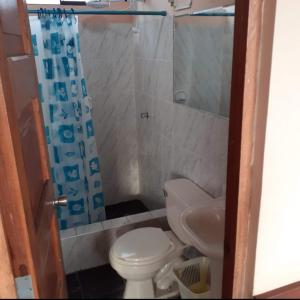 a small bathroom with a toilet and a sink at Alojamiento Punta Negra in Punta Negra