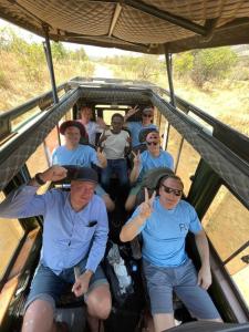 eine Gruppe von Personen, die hinten im Fahrzeug sitzen in der Unterkunft KABA Local Rwandan Guesthouse Entire Property for you with Tour services in and out the city such as Safari's in Kigali