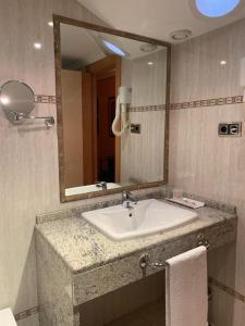 a bathroom with a sink and a mirror at Hospederia La Cañada in Moralzarzal