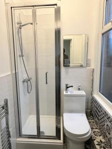 a bathroom with a shower and a toilet and a sink at Lovely Town house Room 3 in Parkside