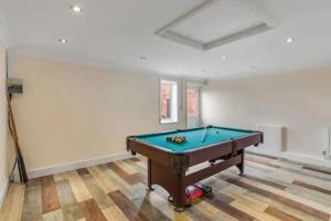 a room with a pool table in it at amazing barn conversion with hot tub in North Walsham
