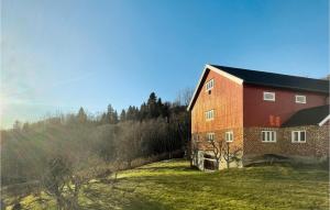 a large red brick building on a grass field at Pet Friendly Home In Svorkmo With House A Panoramic View 
