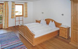 a bedroom with a wooden bed and a window at Nice Apartment In Hainzenberg With House A Mountain View in Zell am Ziller