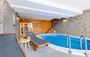 a pool in a room with a chair and a table at Pet Friendly Home In Petrinja With Wi-fi in Petrinja