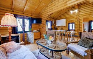 a living room with a table in a cabin at Pet Friendly Home In Petrinja With Wi-fi in Petrinja