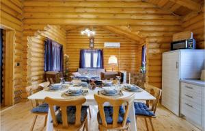 a dining room with a table in a log cabin at Pet Friendly Home In Petrinja With Wi-fi in Petrinja