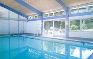 a swimming pool in a house at Cozy Apartment In Nex With Kitchen in Neksø