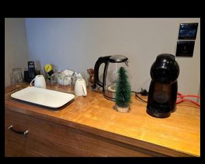 a counter with a coffee pot and a christmas tree on it at Chambre Hôtel Ibiza Spa - Hammam - Jacuzzis - Piscine Chauffée in Les Deux Alpes