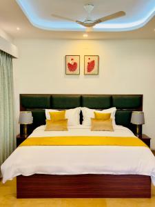 a bedroom with a large bed with a green headboard at Tea & Sky Munnar in Munnar