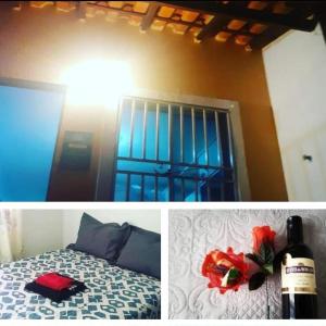 1 dormitorio con 1 cama y 1 botella de vino en Casa Roma Cidade Ocidental, en Cidade Ocidental