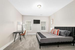 a bedroom with a bed and a desk in it at Modern 2BR 2BA New Build Condo with Garage & Patio in Wyoming