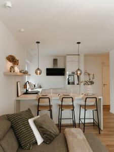 a living room and kitchen with a couch and a table at Appartement Grünoase - zentrumsnah in Detmold