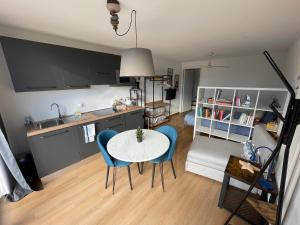 a kitchen and living room with a table and chairs at Escapade Ticino in Neggio