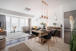 a kitchen and living room with a table and chairs at Premier Pest Side Apartment in Budapest