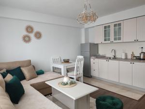 a living room with a couch and a table at Apartman DBB Nikšić in Nikšić