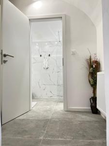 an open door in a room with a stone wall at Under Castle Apartment in Ljubljana