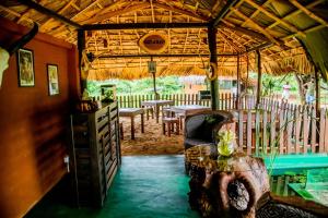 a living room with a table and chairs in a room at Animal View Point Yala in Tissamaharama