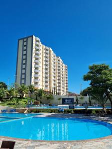 a large building in front of a large swimming pool at Flat 317 Golden Dolphin Express in Caldas Novas
