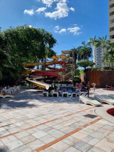 a park with benches and a water slide at Flat 317 Golden Dolphin Express in Caldas Novas