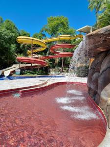 a pool of red water in front of a water park at Flat 317 Golden Dolphin Express in Caldas Novas