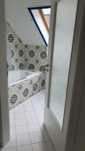a bathroom with a bath tub and a window at Central Starnberg and surrounded by nature in Starnberg