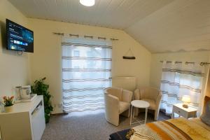 a bedroom with a bed and a window and a tv at myCozyPlace - Zwei gemütliche Zimmer für Vier in Dresden