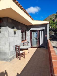 a patio of a house with a table and a bench at Winter Wonderland Villa in Tamaimo