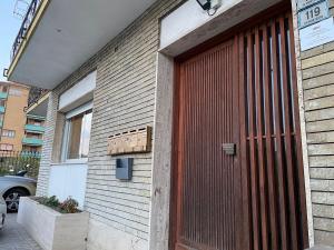 a building with a red door on the side of it at Right Bank House in Imperia