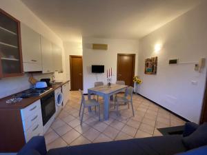 a kitchen with a table and chairs in a room at Right Bank House in Imperia