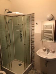 a bathroom with a shower and a sink at Moon River Guest House in Pescara