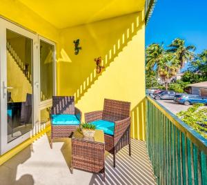 two chairs and a table on a balcony at Apartment in downtown at the beach in Nassau