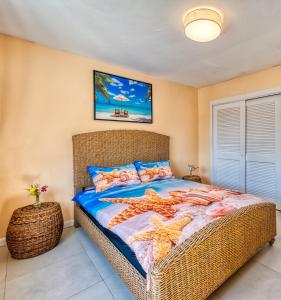 a bedroom with a large bed with star cushions at Apartment in downtown at the beach in Nassau