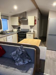 a kitchen with a couch and a table in a kitchen at Lorraine's Caravan Holiday in Morecambe