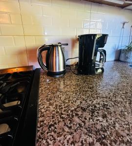 two coffee pots sitting on top of a kitchen counter at Casa en Bariloche Familiar - R2046 in San Carlos de Bariloche