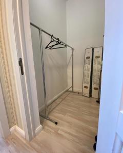 a room with a walk in closet with a glass door at APARTAMENT в мкр Батыс-2 в комфортном ЖК Нектар in Aktobe