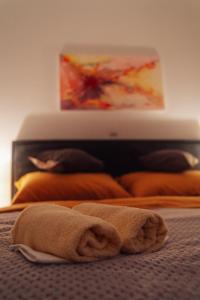 a towel laying on top of a bed with a laptop at Apartman Arija - Self Check In in Osijek