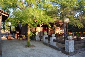a building with potted trees and flowers in pots at B&B Le Stagioni in Castel del Monte