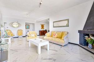 a living room with a couch and a table at Villa Marite - 4 bed/ 2 bath - own private pool in Fuengirola