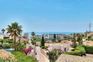 a view of a city with palm trees and buildings at Villa Marite - 4 bed/ 2 bath - own private pool in Fuengirola