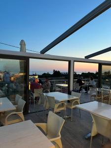 a restaurant with tables and chairs and people sitting at tables at Blue Sky in Frangokastello