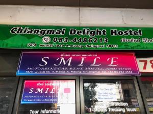 a sign above a store window with signs on it at Chiangmai Delight Hostel in Chiang Mai