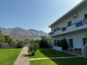 a view of a house with mountains in the background at Blue Sky in Frangokastello