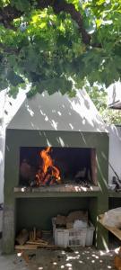 an outdoor fireplace with a fire in it at ALOJAMIENTO SARMIENTO in General Alvear