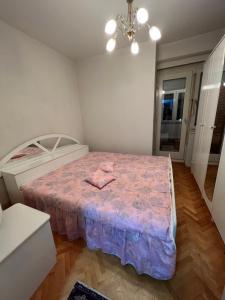 a bedroom with a bed with a pink blanket at Two luxury bedroom apartment D&V in Berovo