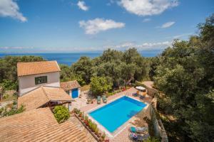 an aerial view of a villa with a swimming pool at Marguerita House in Georgoutsátika