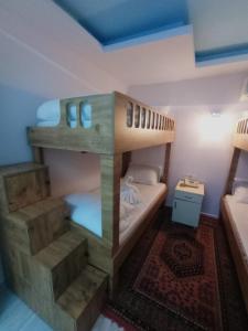 a bedroom with two bunk beds and a rug at Sultan Terrace Hostel in Istanbul