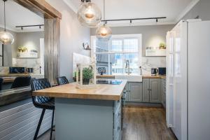 a kitchen with white cabinets and a kitchen island at Heart of Reykjavik-Luxury Apartments in Reykjavík
