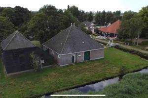 an aerial view of a house on a river at Beautiful farmhouse near Amsterdam center in Watergang