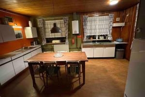 a large kitchen with a wooden table and chairs at Beautiful farmhouse near Amsterdam center in Watergang