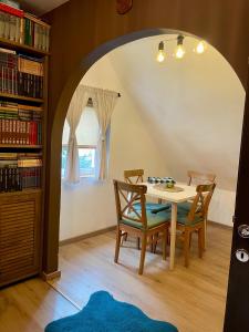 a dining room with a table and two chairs at Guest House Durmitor Paradise in Žabljak